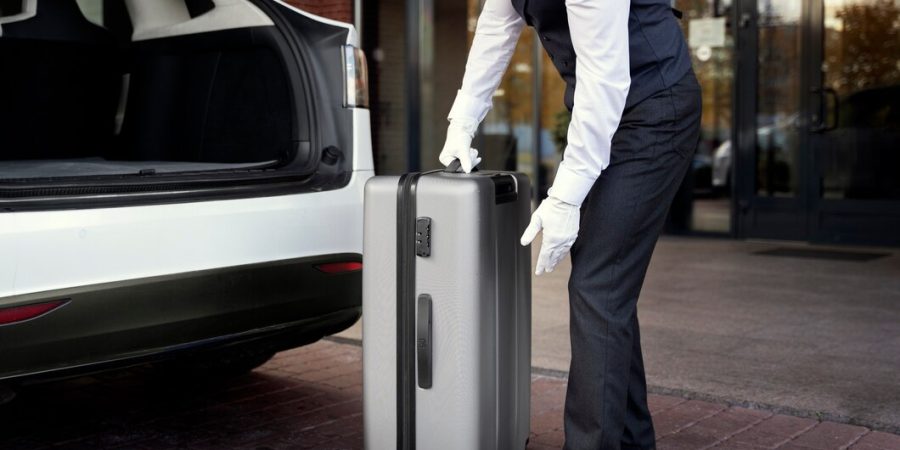 side-view-valet-holding-baggage_23-2149901447